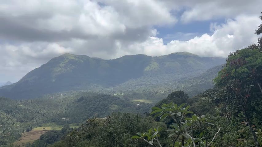 The valley and the hills beyond under a sky of moving cloud