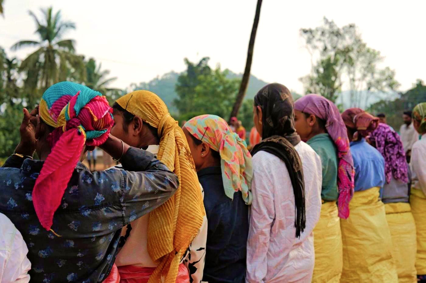 Women in bright headscarves and shawls gathered together