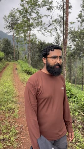 Pulkit on the biodiversity walk, down the red earth track between the trees
