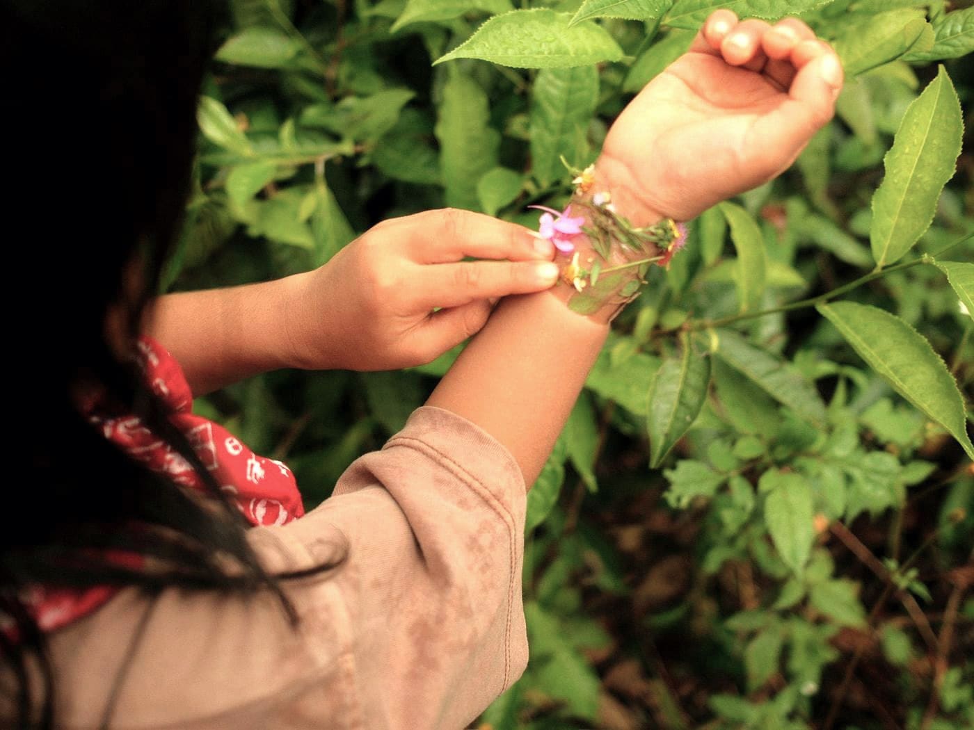 Tying a bracelet of flowers around a wrist