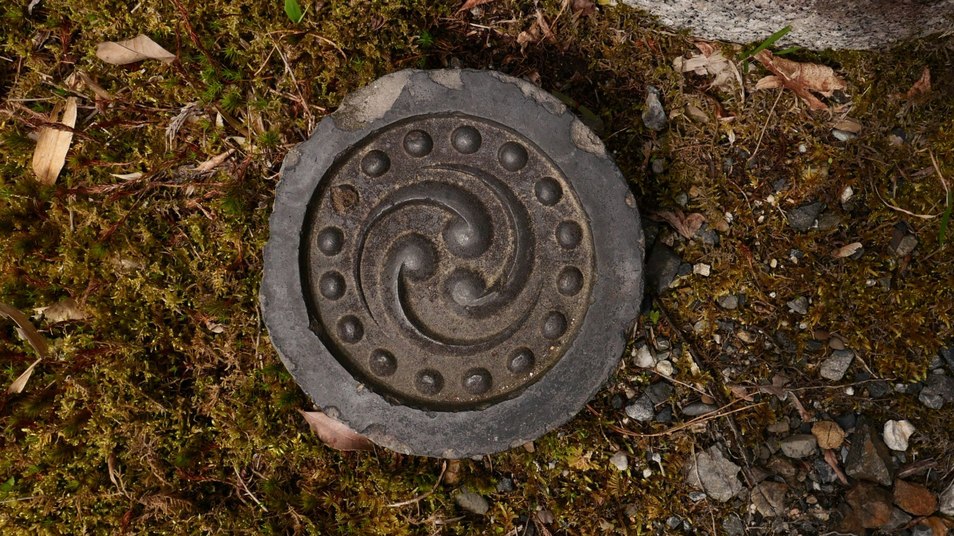 A carved emblem kept from the original home