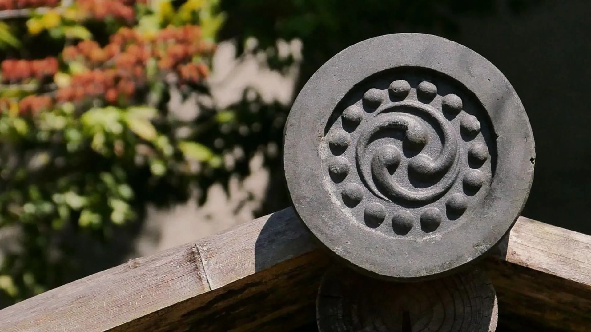 A carved stone water basin set into a garden